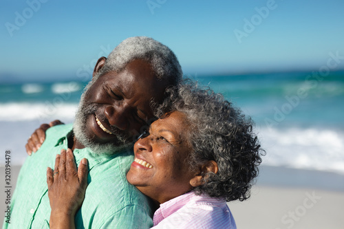 Old couple in love at the beach