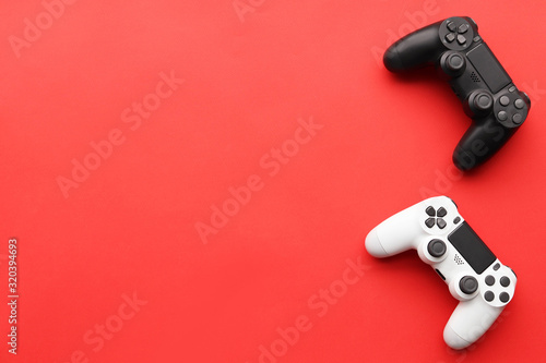 Game joysticks, gaming device on a red background space for text photo