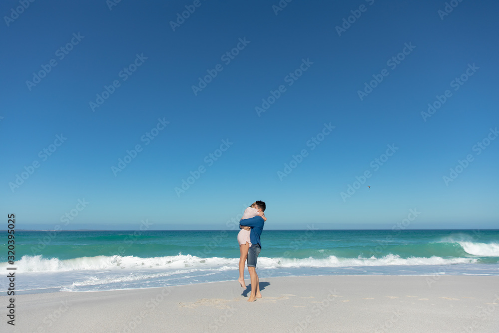 Young couple hugging at the beach