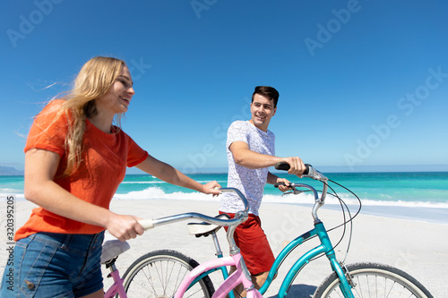 Young couple with bikes at the beach