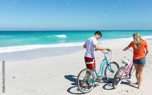 Young couple with bikes at the beach