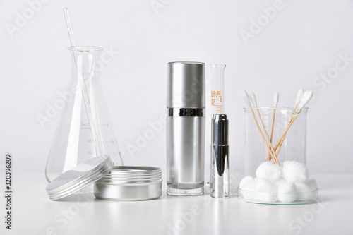 Cosmetic bottle containers and scientific glassware, Blank package for branding mock-up, Pharmaceutical skincare by dermatologist doctor, Research and develop beauty product concept.