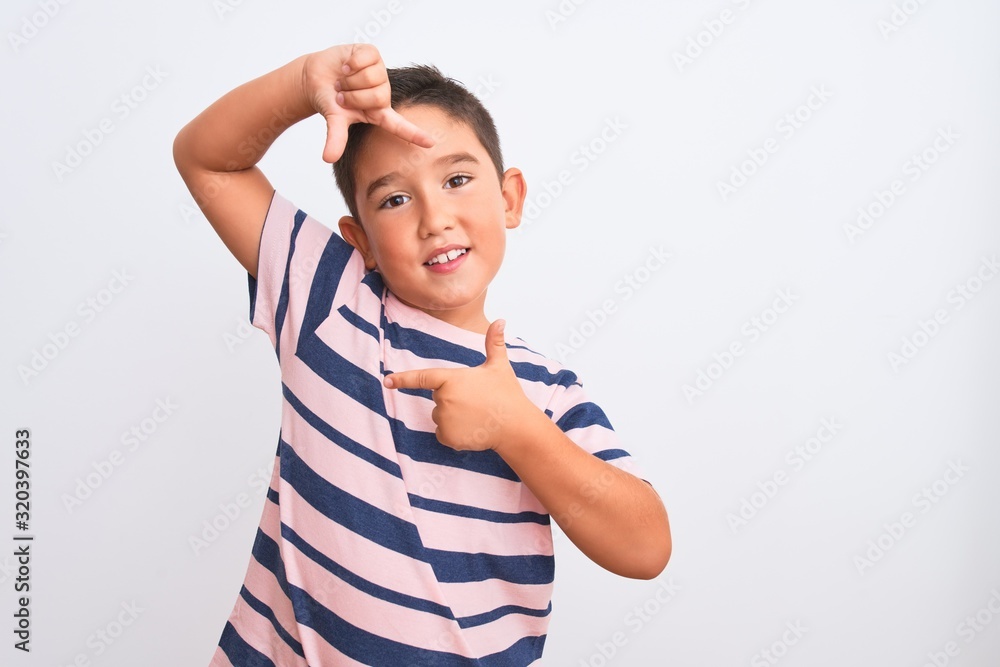 Beautiful kid boy wearing casual striped t-shirt standing over isolated white background smiling making frame with hands and fingers with happy face. Creativity and photography concept. Beautiful kid boy wearing casual striped t-shirt standing over isolated white background smiling making frame with hands and fingers with happy face. Creativity and photography concept.