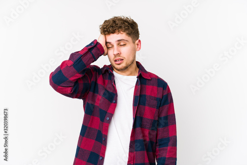 Young blond curly hair caucasian man isolated being shocked, she has remembered important meeting.