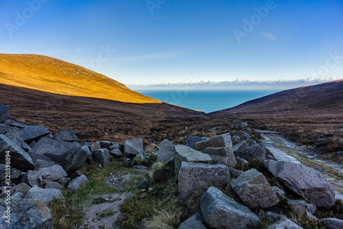 Mourne Mountains are the highest and most dramatic mountain range in Northern Ireland. View from valley near Slieve Donard mountain peak on Irish Sea photo