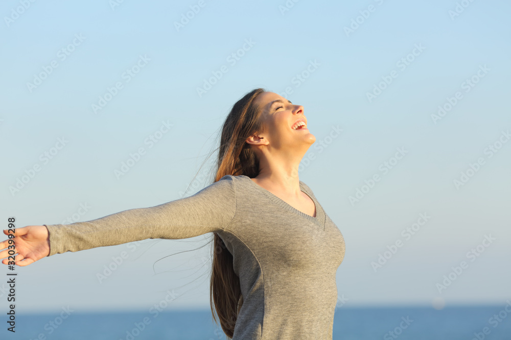 Happy woman celebrating good day on the beach Happy woman celebrating good day on the beach