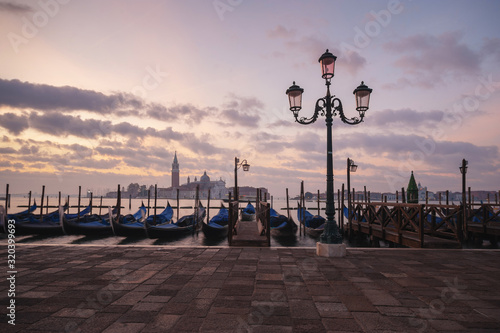 famous gondolas at sunrise. Venice, Italy. picture with long exposure