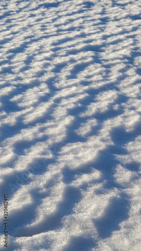 Texture of snow. The snow lit background.