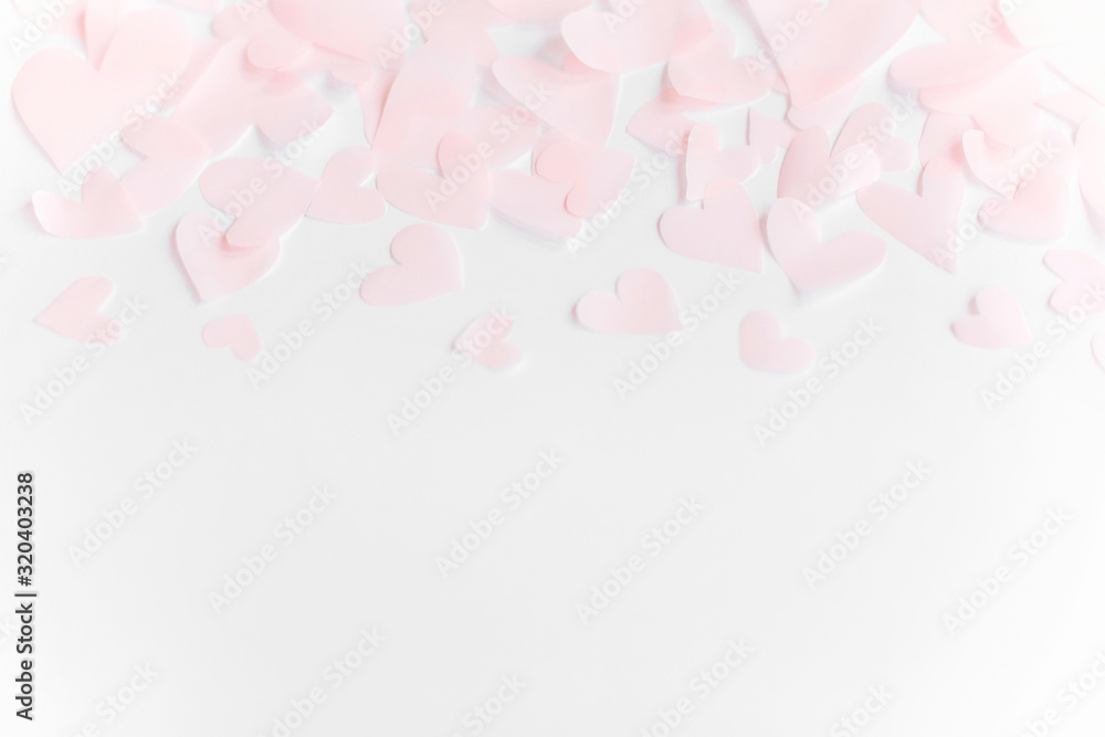 Cute pink pastel hearts border on white paper  background with copy space. Happy valentines day. Pink paper heart cutouts on white backdrop, gentle image, greeting card.