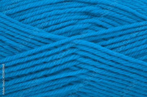 Yarn for knitting, natural wool. Classic blue color, monochrome. Close-up, background