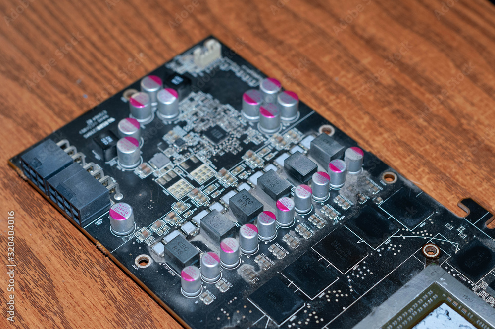 soft focus of part of disassembled graphics card for computer on wooden surface in home improvement soft focus of part of disassembled graphics card for computer on wooden surface in home improvement