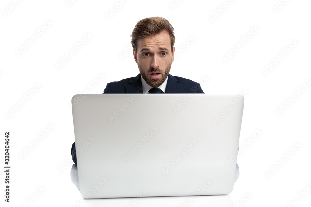 shocked young businessman in navy blue suit reading emails