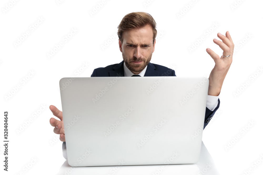 confused young businessman in navy suit reading emails confused young businessman in navy suit reading emails