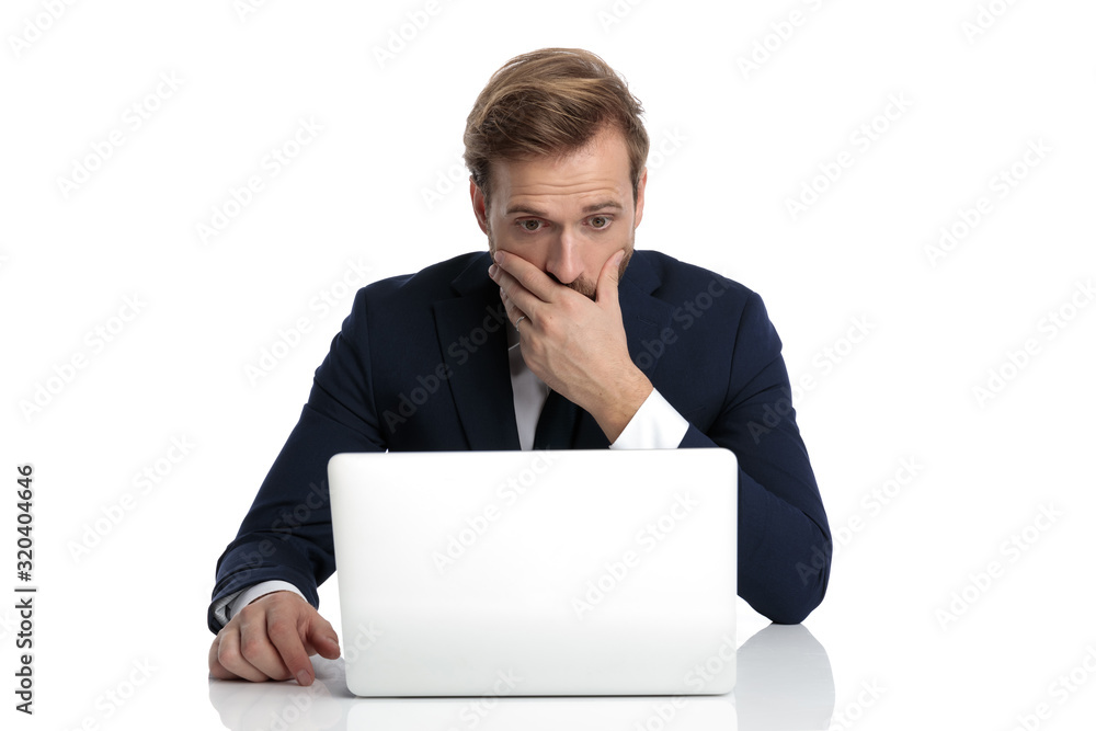 shocked young businessman in navy suit covering mouth with hand shocked young businessman in navy suit covering mouth with hand