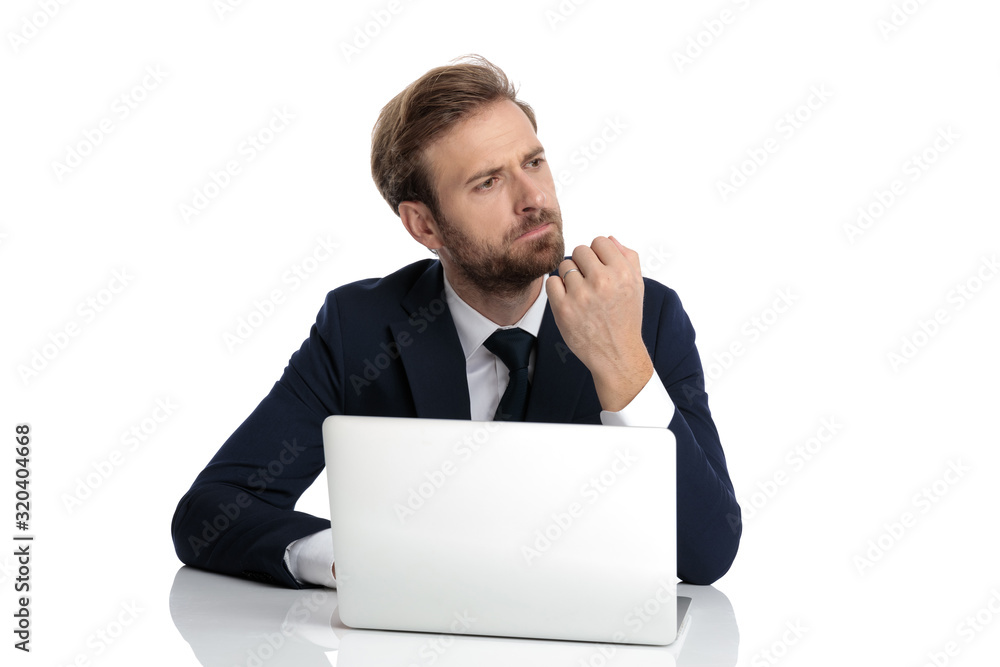 thoughtful young businessman in navy blue suit looking to side thoughtful young businessman in navy blue suit looking to side