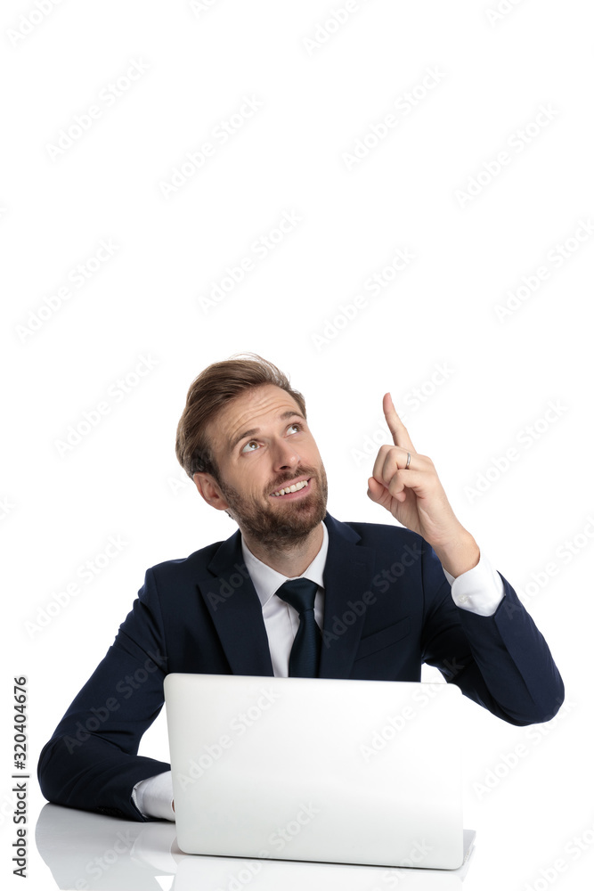 happy businessman in navy blue suit pointing finger above happy businessman in navy blue suit pointing finger above