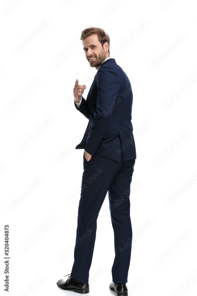 happy young businessman smiling and pointing finger happy young businessman smiling and pointing finger