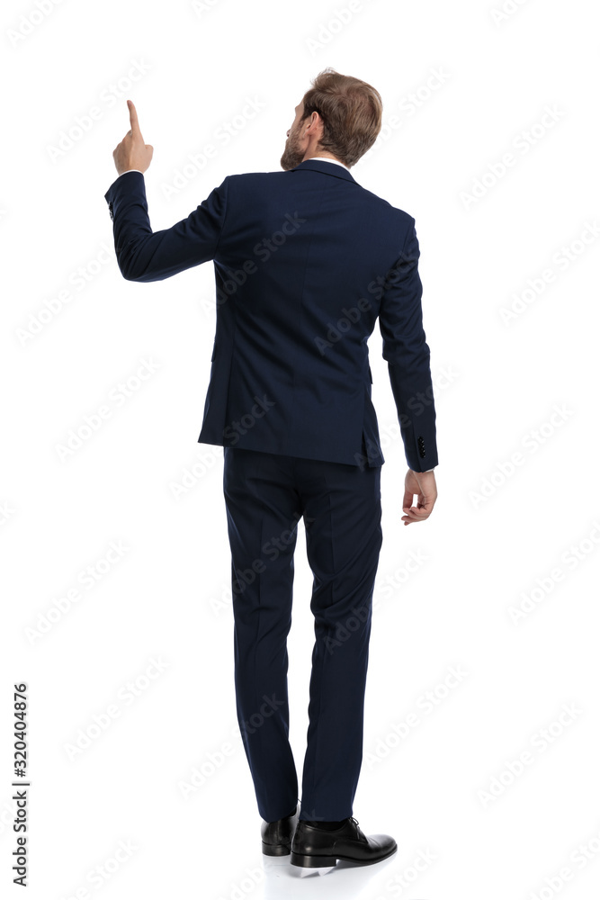 young businessman in navy blue suit pointing finger young businessman in navy blue suit pointing finger