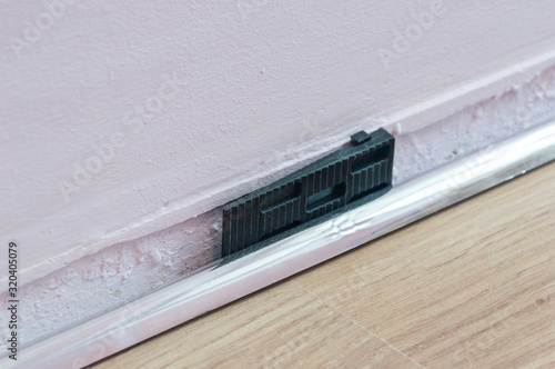 Cuadro en lienzo Black dilation wedge during laying laminate flooring