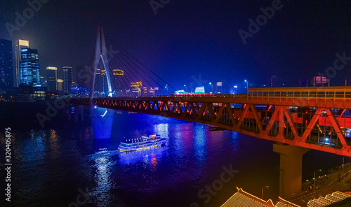 Night view of Chongqing city.  View of the bridge over the river.  Lighting and office buildings.  River reflections and lights.  Cityscape