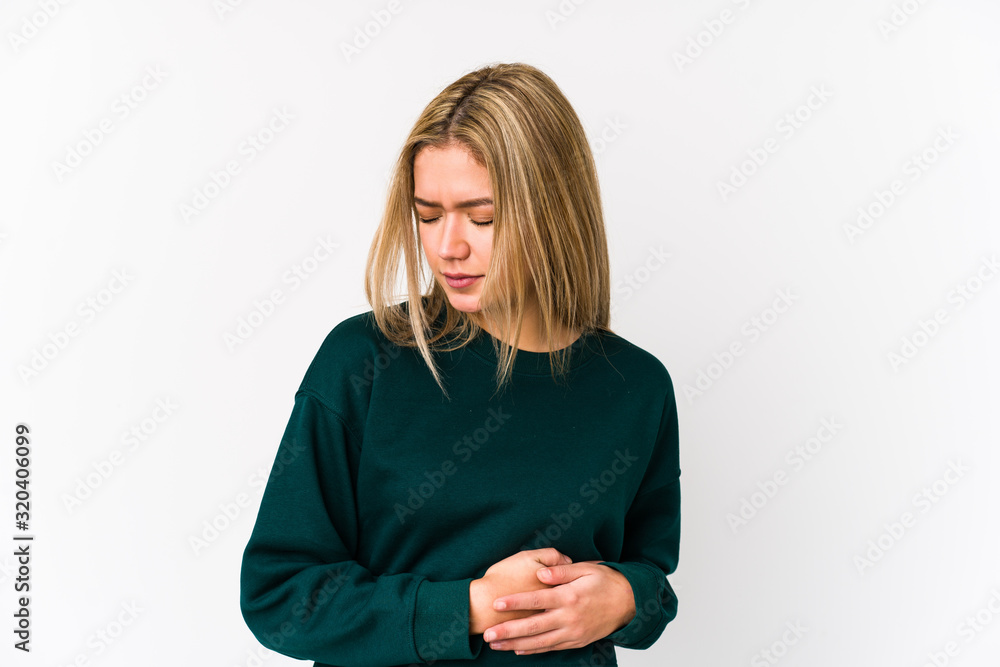 Young blonde caucasian woman isolated having a liver pain, stomach ache. Young blonde caucasian woman isolated having a liver pain, stomach ache.