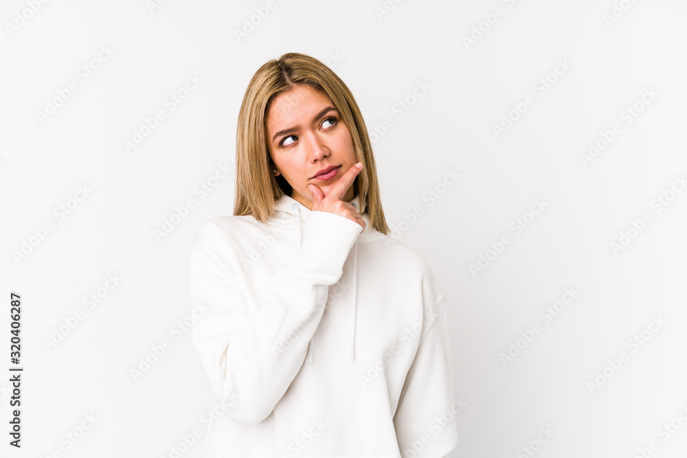 Young blonde caucasian woman isolated thinking and looking up, being reflective, contemplating, having a fantasy. Young blonde caucasian woman isolated thinking and looking up, being reflective, contemplating, having a fantasy.