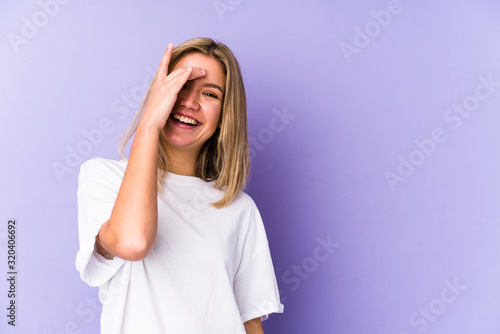 Young blonde caucasian woman isolated laughing happy, carefree, natural emotion.