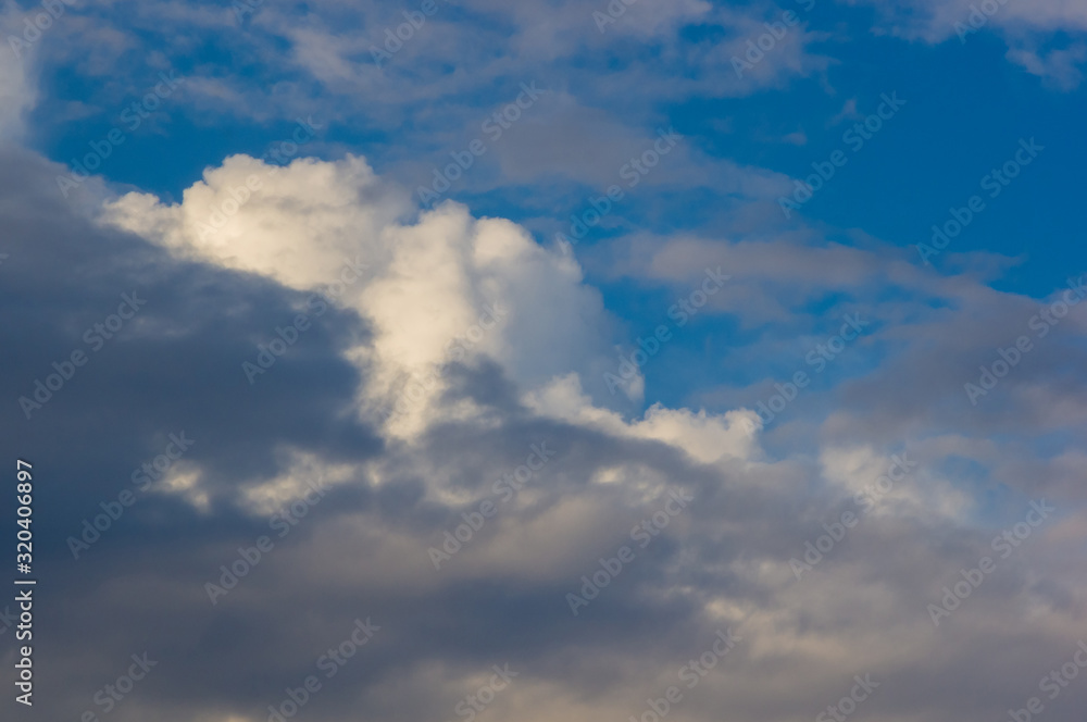 White clouds in the blue summer sky, beautiful dramatic lighting