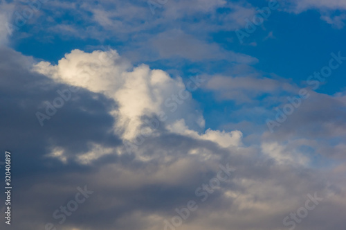 White clouds in the blue summer sky, beautiful dramatic lighting
