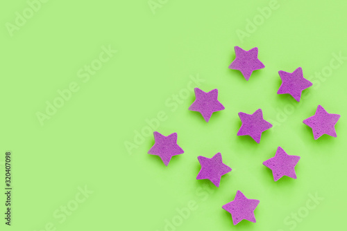 Pink stars on light green background  place for text. pink cookies. Copy space. Mock up