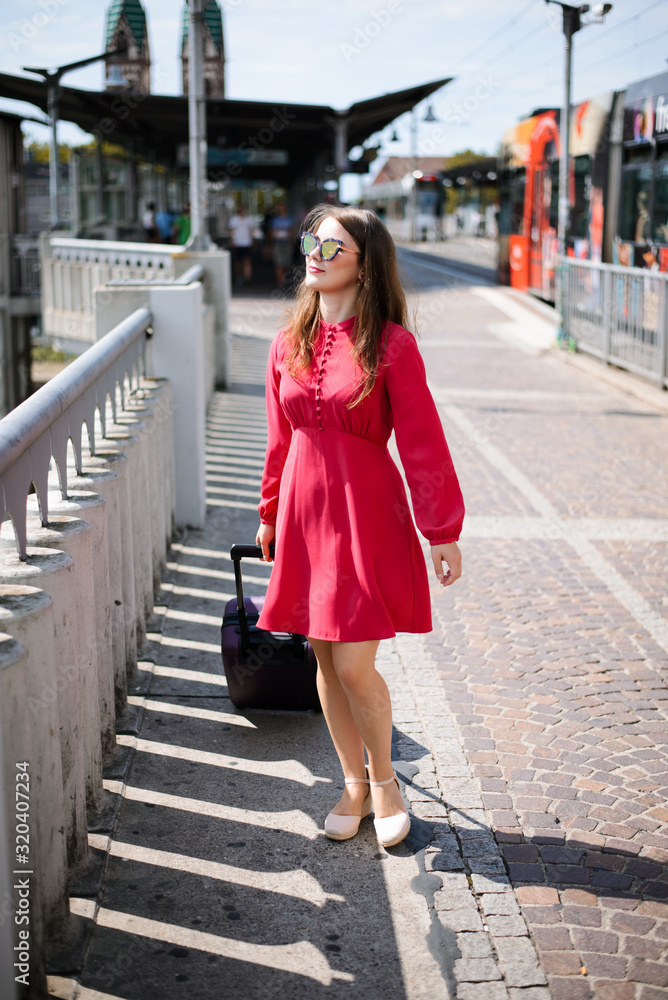 Young girl traveler is going to set out to the trip. Concept of travelling Young girl traveler is going to set out to the trip. Concept of travelling