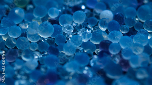 Tableau sur toile Close up - Pile of silica gel on blue background, Desiccant used in industrial, moisture protection