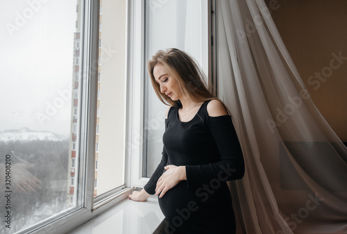 A pregnant girl is breathing fresh air from the window Free Download A pregnant girl is breathing fresh air from the window - GFXLoad