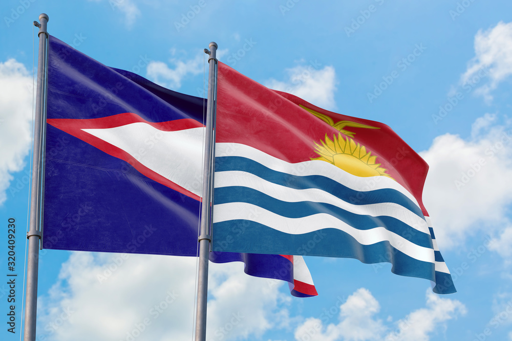 Kiribati and American Samoa flags waving in the wind against white cloudy blue sky together. Diplomacy concept, international relations. Kiribati and American Samoa flags waving in the wind against white cloudy blue sky together. Diplomacy concept, international relations.