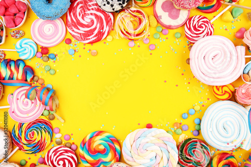 candies with jelly and sugar and streamers. colorful array of different childs sweets and treats.