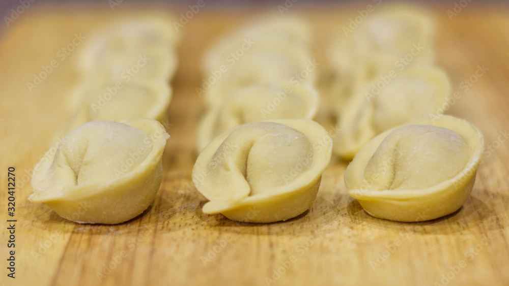 Traditional Russian dumplings hand-made on a cutting Board.
