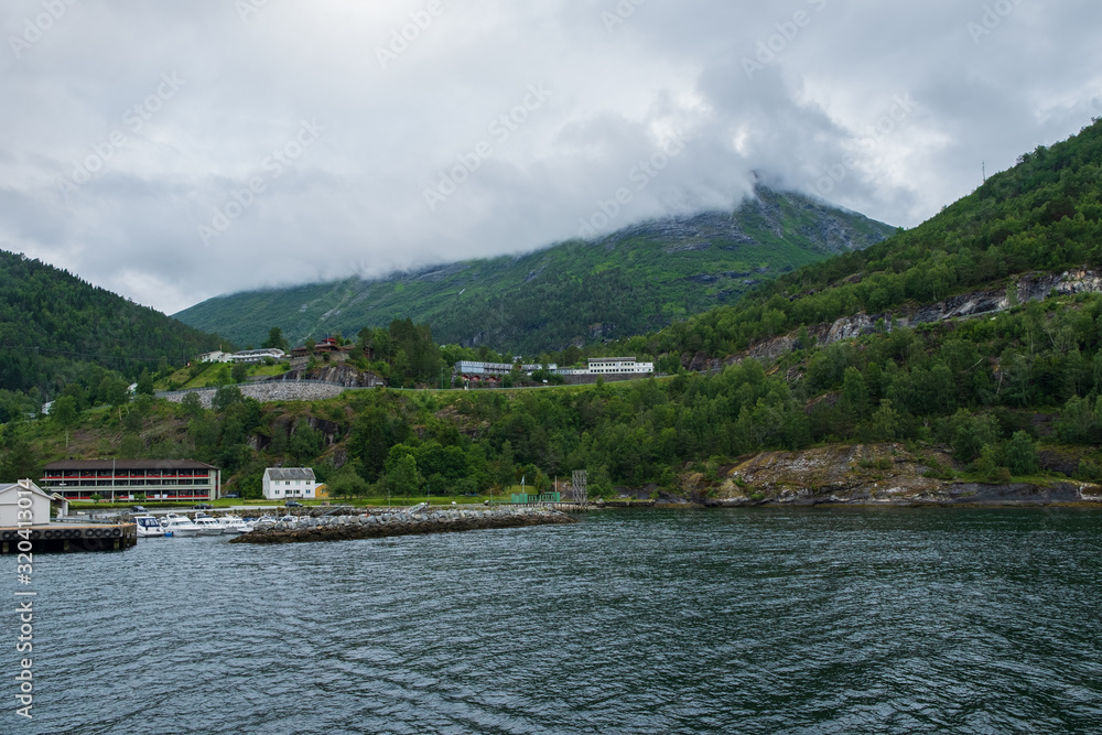 Blue water of Geirangerfjord as seen from the town Hellesylt, More og Romsdal, Norway. July 2019