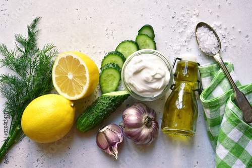 Ingredients for making traditional greek sauce tzatziki. Top view with copy space. photo