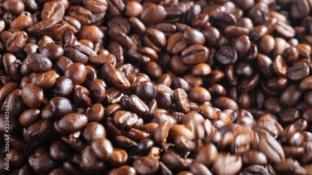 Roasted coffee beans with smoke in a frying pan. Roasted coffee beans with smoke in a frying pan.