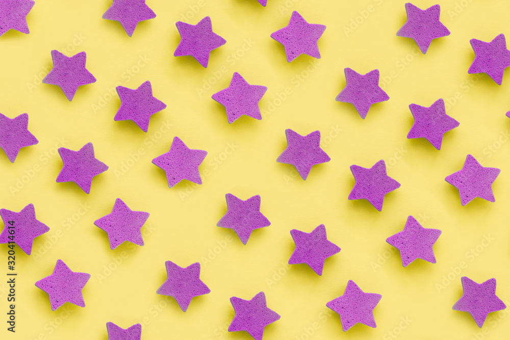 Pink stars on yellow background, place for text. pink cookies. Copy space. Mock up Pink stars on yellow background, place for text. pink cookies. Copy space. Mock up