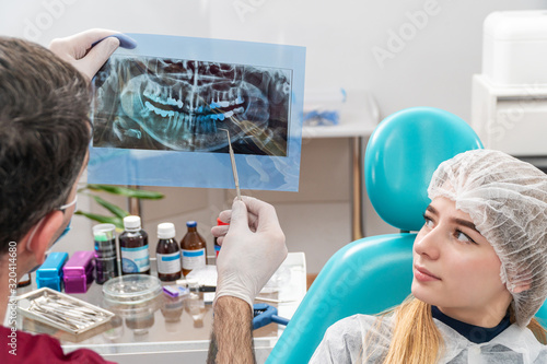 dentist shows a picture of the jaw