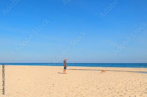 Corsica beach landscape with man and dog