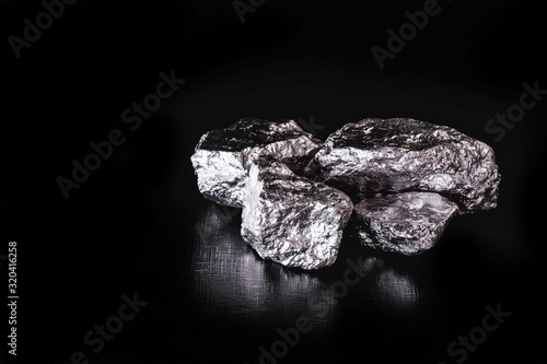Platinum is a chemical element used in the chemical industry as a catalyst for the production of nitric acid, silicone and benzene. Crude platinum stone, industrial use. photo