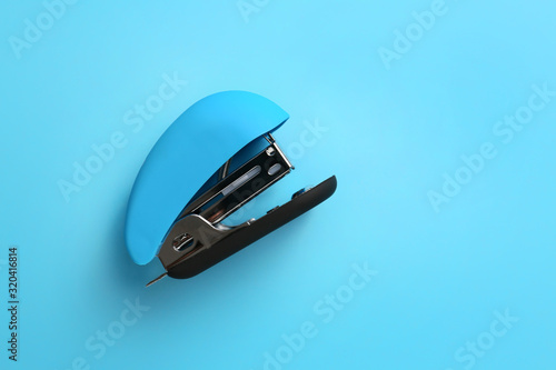 Office stapler on color background photo