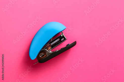 Office stapler on color background photo