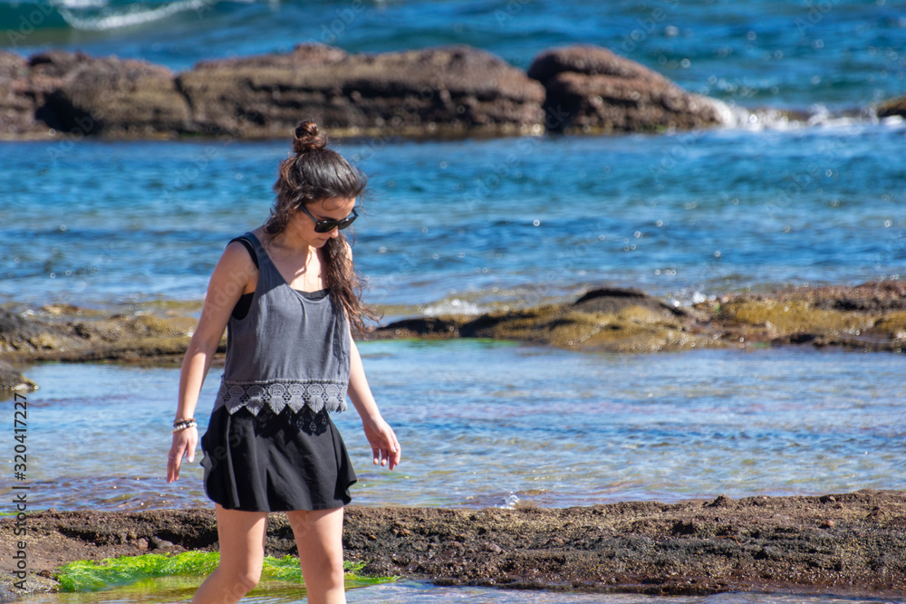 young woman walking on the beach young woman walking on the beach