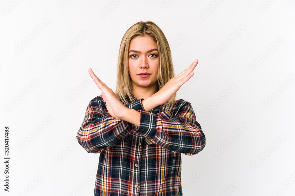 Young blonde caucasian woman isolated keeping two arms crossed, denial concept. Young blonde caucasian woman isolated keeping two arms crossed, denial concept.