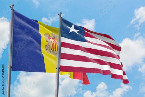 Liberia and Andorra flags waving in the wind against white cloudy blue sky together. Diplomacy concept  international relations.