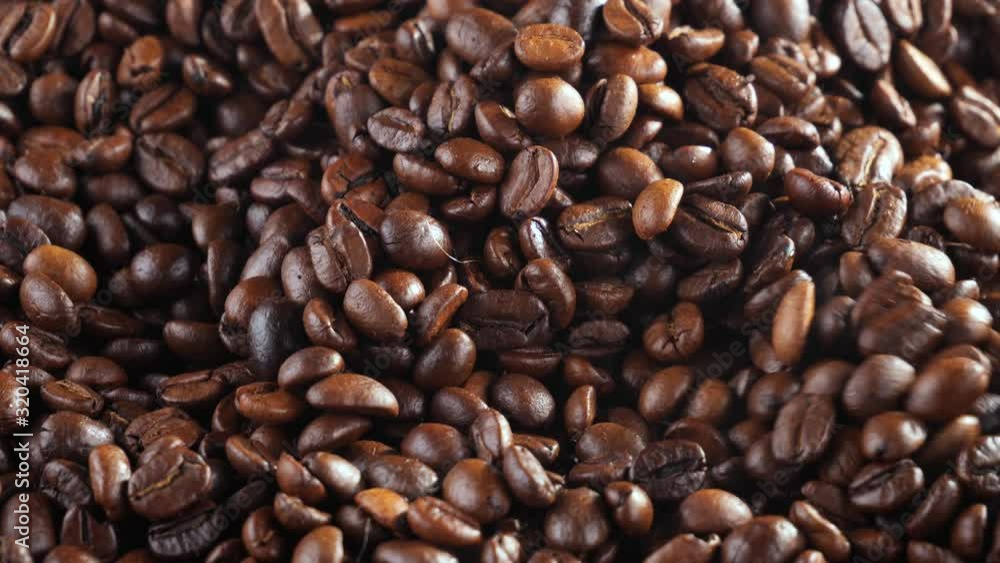 The coffee beans are roasted and mixed with a spoon. The coffee beans are roasted and mixed with a spoon.