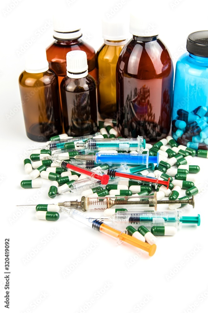 Syringe and drugs on white background. Flu vaccination. Treatment of viral disease. Prevention of influenza. Syringe and drugs on white background. Flu vaccination. Treatment of viral disease. Prevention of influenza.